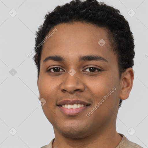 Joyful latino young-adult male with short  brown hair and brown eyes