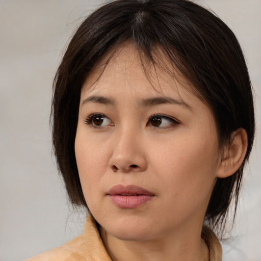 Neutral asian young-adult female with medium  brown hair and brown eyes