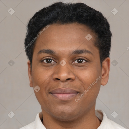 Joyful black young-adult male with short  brown hair and brown eyes