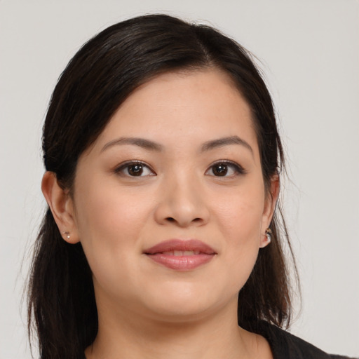 Joyful asian young-adult female with long  brown hair and brown eyes