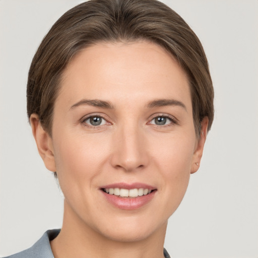 Joyful white young-adult female with short  brown hair and grey eyes