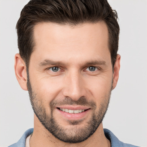 Joyful white young-adult male with short  brown hair and brown eyes