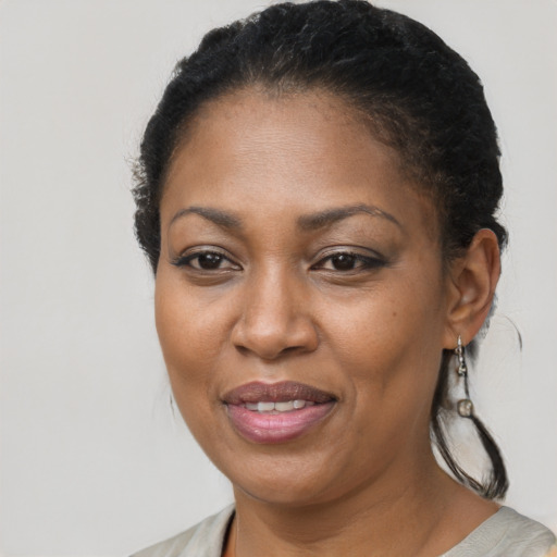 Joyful black adult female with short  brown hair and brown eyes