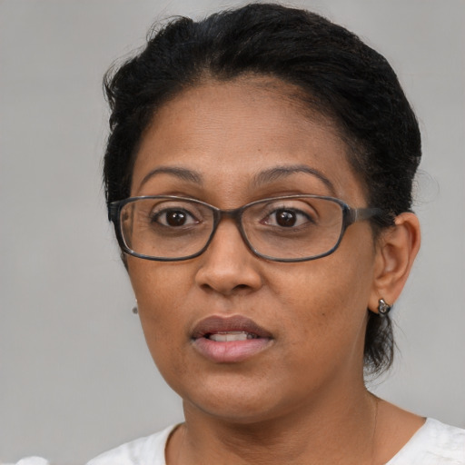 Neutral latino adult female with short  brown hair and brown eyes