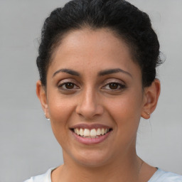 Joyful latino young-adult female with short  brown hair and brown eyes