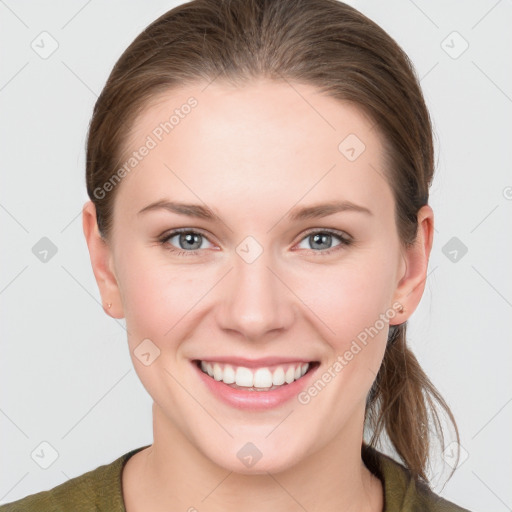 Joyful white young-adult female with long  brown hair and grey eyes