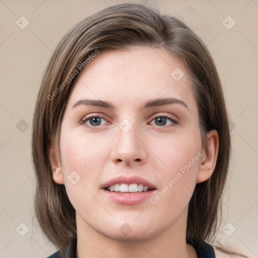 Joyful white young-adult female with medium  brown hair and grey eyes