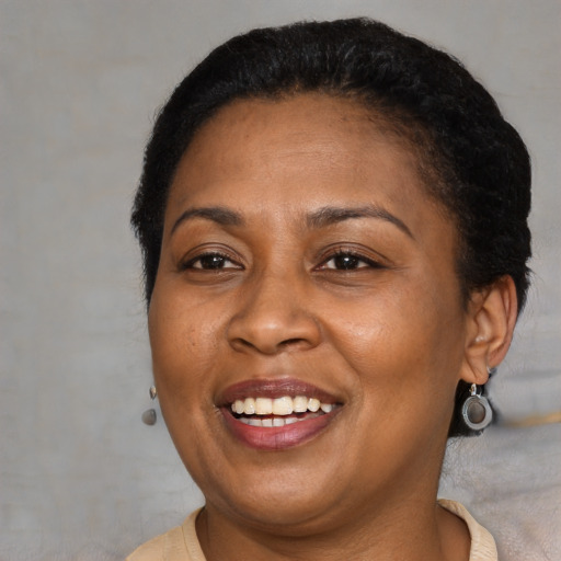 Joyful latino adult female with short  brown hair and brown eyes