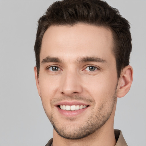 Joyful white young-adult male with short  brown hair and brown eyes