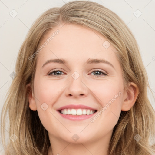 Joyful white young-adult female with long  brown hair and blue eyes