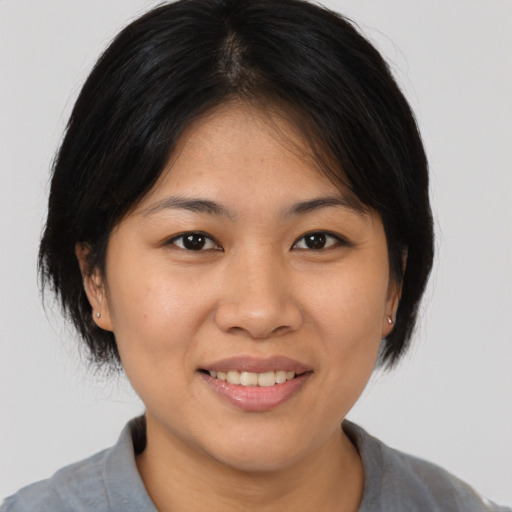 Joyful white young-adult female with medium  brown hair and brown eyes