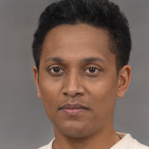 Joyful latino adult male with short  brown hair and brown eyes
