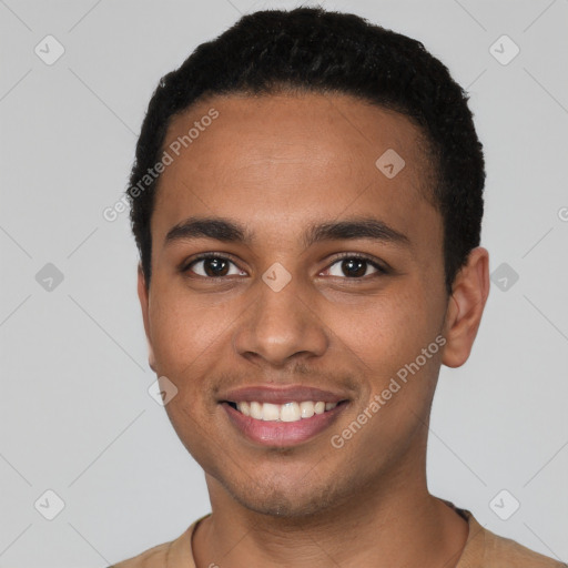 Joyful black young-adult male with short  black hair and brown eyes