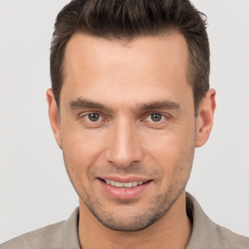 Joyful white young-adult male with short  brown hair and brown eyes