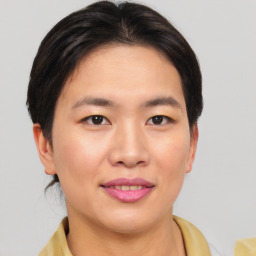 Joyful asian young-adult female with short  brown hair and brown eyes