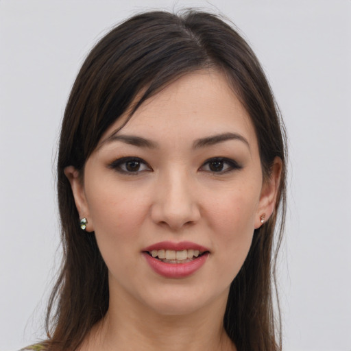 Joyful white young-adult female with long  brown hair and brown eyes