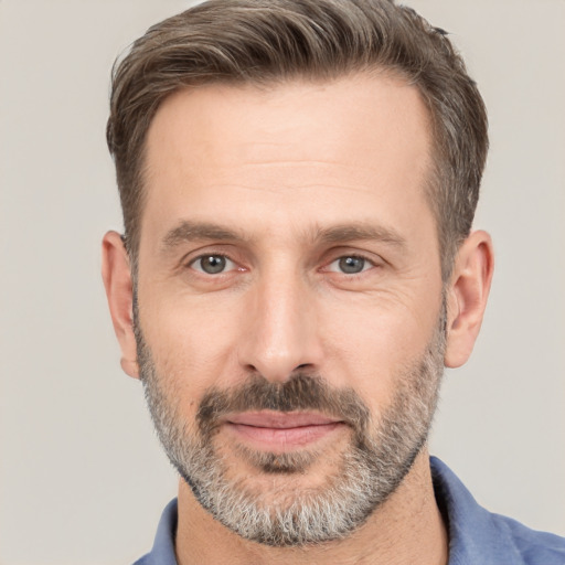 Joyful white adult male with short  brown hair and brown eyes