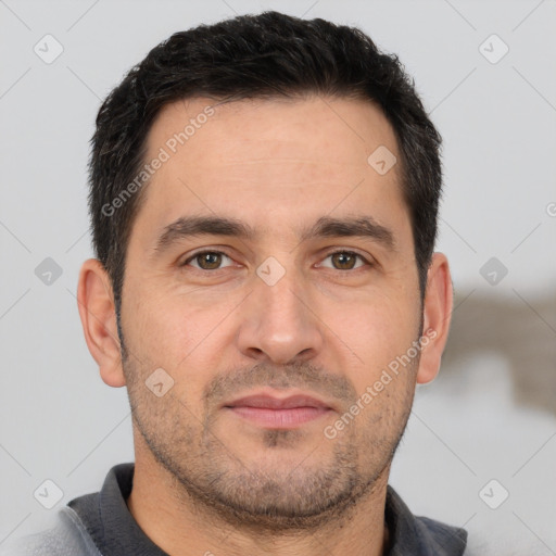 Joyful white adult male with short  brown hair and brown eyes