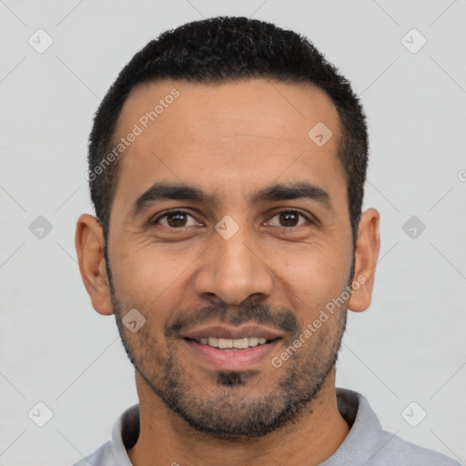 Joyful latino young-adult male with short  black hair and brown eyes