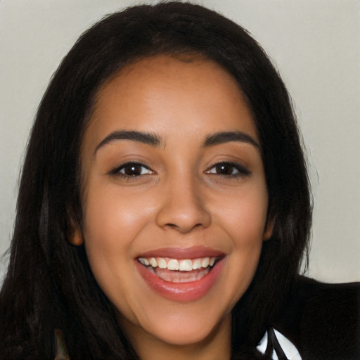 Joyful latino young-adult female with long  black hair and brown eyes