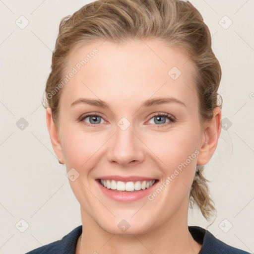 Joyful white young-adult female with medium  brown hair and blue eyes