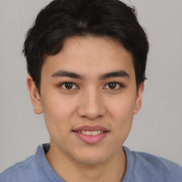 Joyful asian young-adult male with short  brown hair and brown eyes