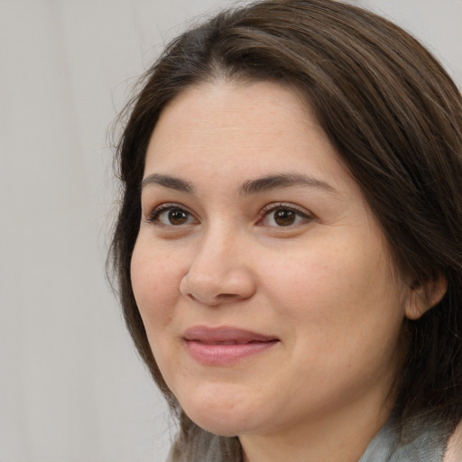 Joyful white adult female with medium  brown hair and brown eyes