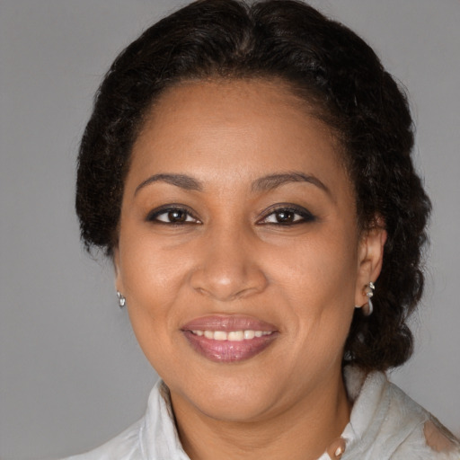 Joyful black adult female with medium  brown hair and brown eyes