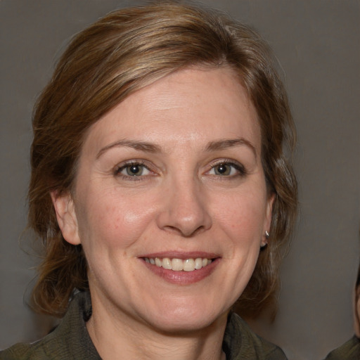 Joyful white adult female with medium  brown hair and grey eyes