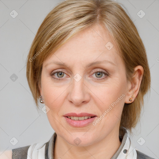 Joyful white adult female with medium  brown hair and blue eyes