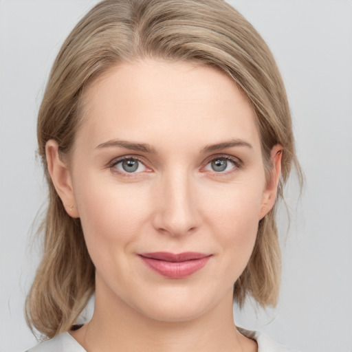 Joyful white young-adult female with medium  brown hair and blue eyes