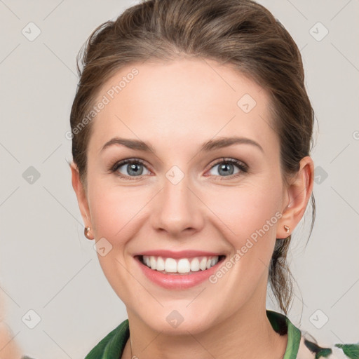 Joyful white young-adult female with medium  brown hair and green eyes