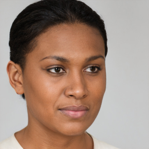 Joyful black young-adult female with short  brown hair and brown eyes