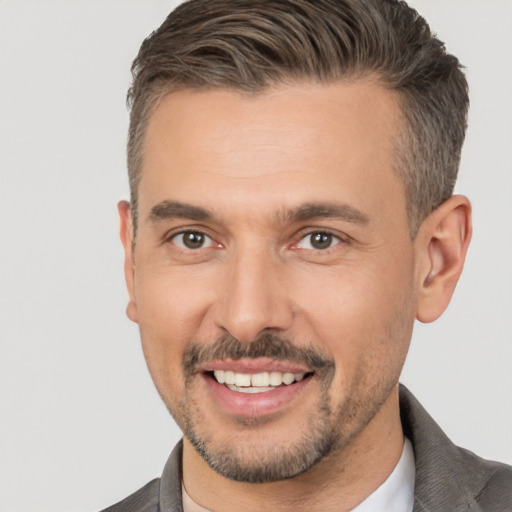 Joyful white adult male with short  brown hair and brown eyes