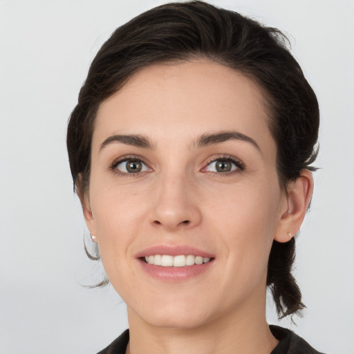 Joyful white young-adult female with medium  brown hair and grey eyes