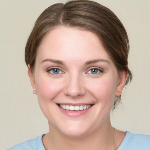 Joyful white young-adult female with medium  brown hair and blue eyes