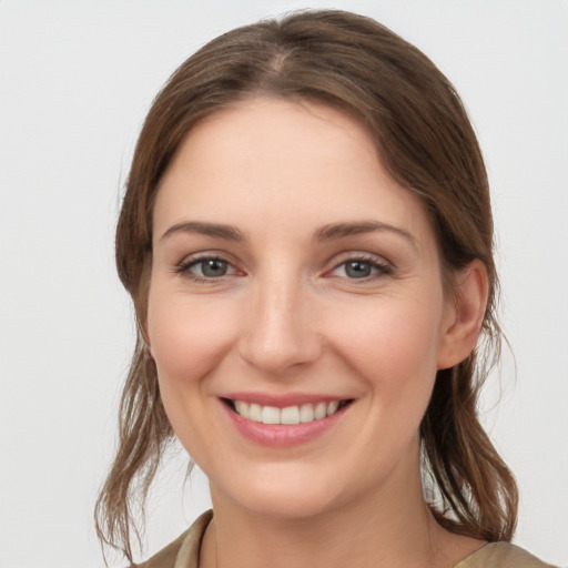 Joyful white young-adult female with long  brown hair and grey eyes