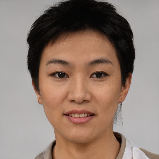 Joyful asian young-adult female with short  black hair and brown eyes