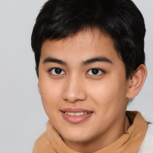 Joyful asian young-adult male with short  brown hair and brown eyes