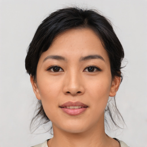 Joyful asian young-adult female with medium  black hair and brown eyes
