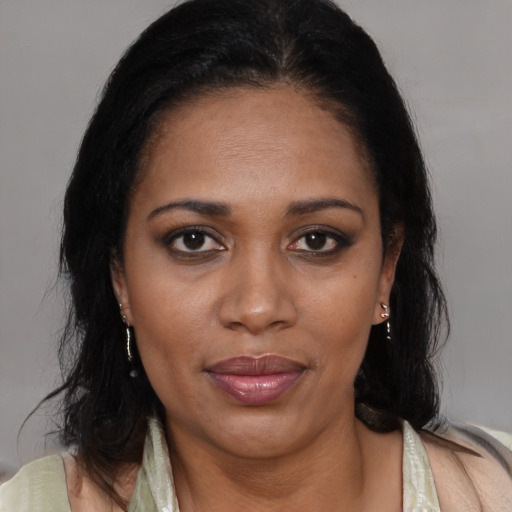 Joyful black adult female with medium  brown hair and brown eyes