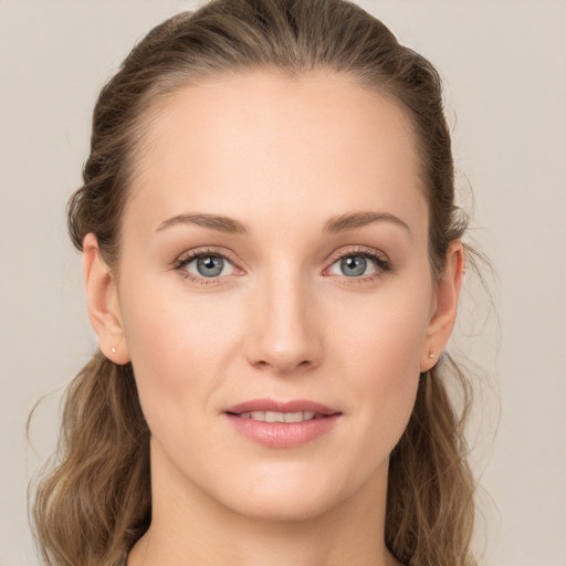 Joyful white young-adult female with long  brown hair and grey eyes