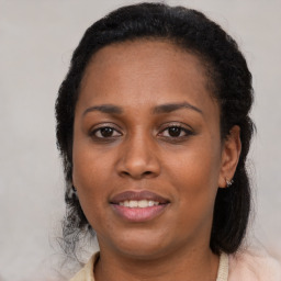 Joyful black adult female with medium  brown hair and brown eyes
