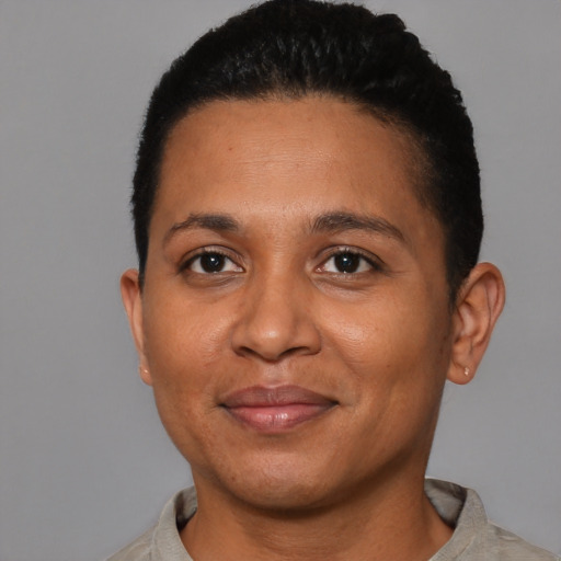Joyful black young-adult female with short  brown hair and brown eyes