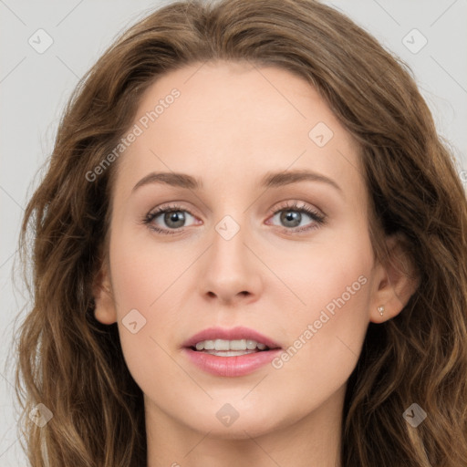 Joyful white young-adult female with long  brown hair and green eyes