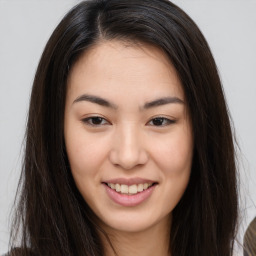 Joyful asian young-adult female with long  brown hair and brown eyes