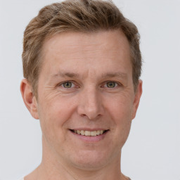 Joyful white adult male with short  brown hair and grey eyes