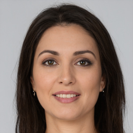 Joyful white young-adult female with long  brown hair and brown eyes