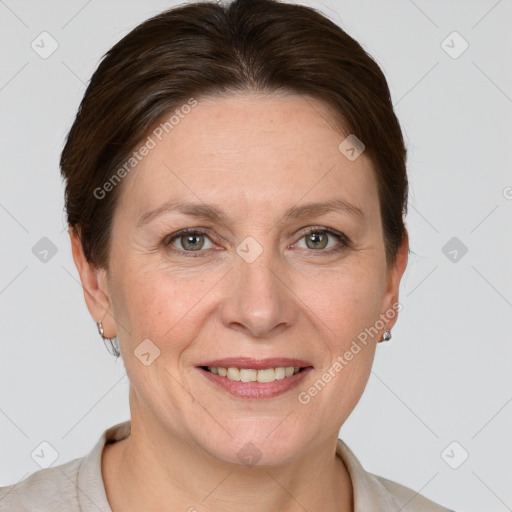 Joyful white adult female with short  brown hair and grey eyes