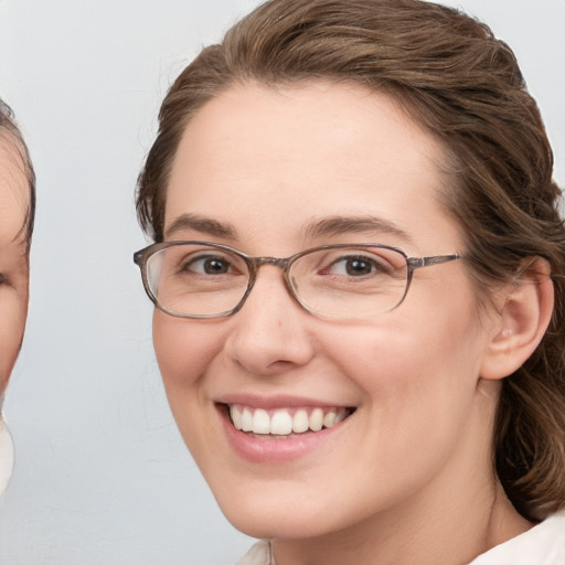 Joyful white young-adult female with medium  brown hair and blue eyes